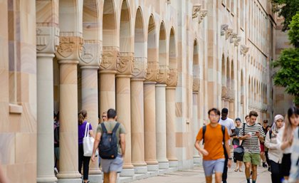 Students walking through the Great Court at UQ St Lucia, which is surrounded by sandstone buildings